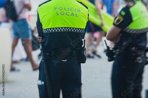Fotografie, Obraz Spanish police squad formation back view with Local Police logo emblem on unif