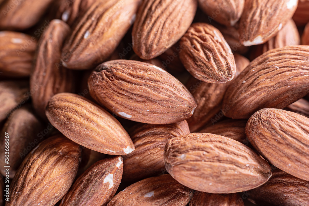 Closeup of shiny peeled almond seeds. Peeled almond texture. Superfood. Natural food. Closeup of shiny peeled almond seeds. Peeled almond texture. Superfood. Natural food.