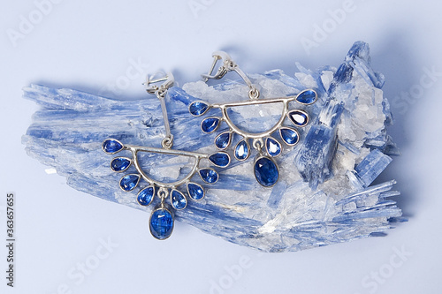 Jewelry earrings with kyanite or distin mineral from Brazil. Blue aluminosilicate mineral with columnar crystals and metamorphic rock. Called two forces.