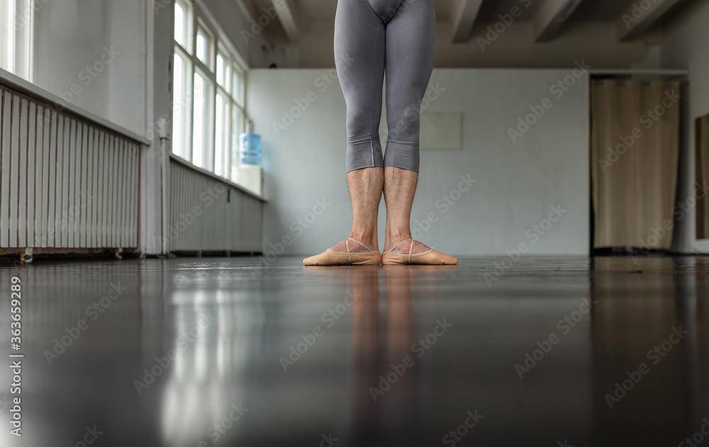 Young man training ballet at school. Young man training ballet at school.