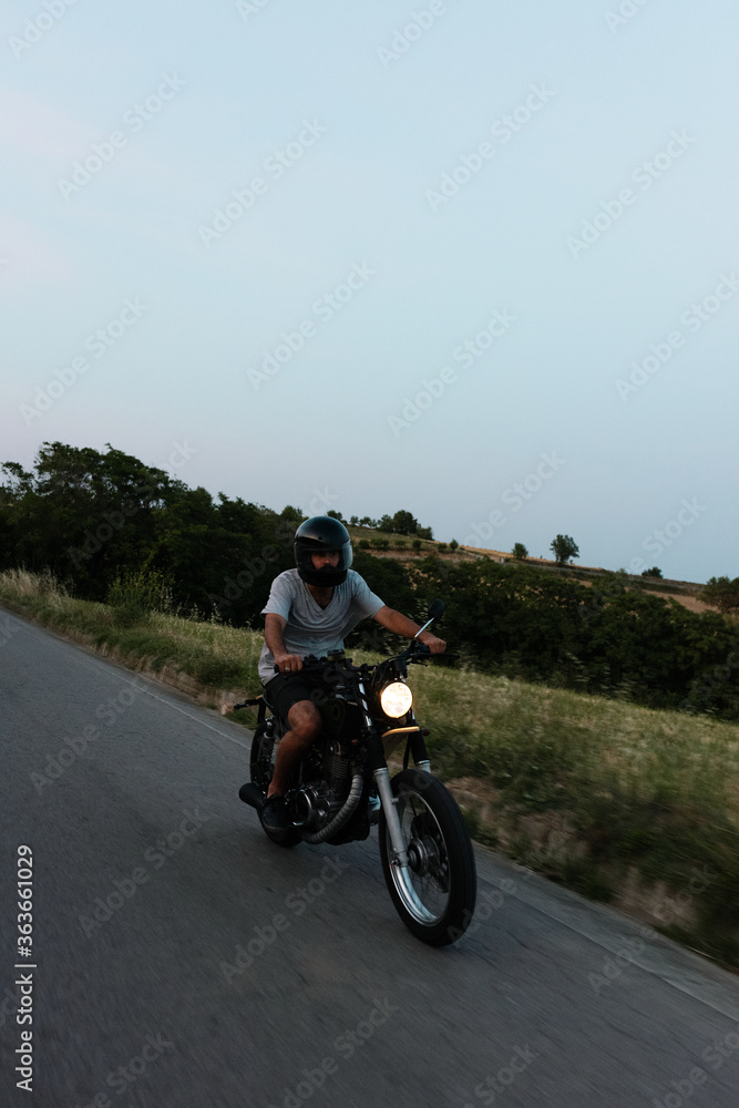 Man riding motorcycle during dusk Man riding motorcycle during dusk