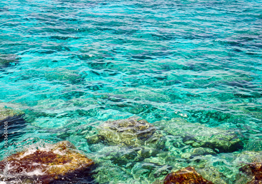 Transparent turquoise sea and colorful stones in the Mediterranean Sea in Cyprus