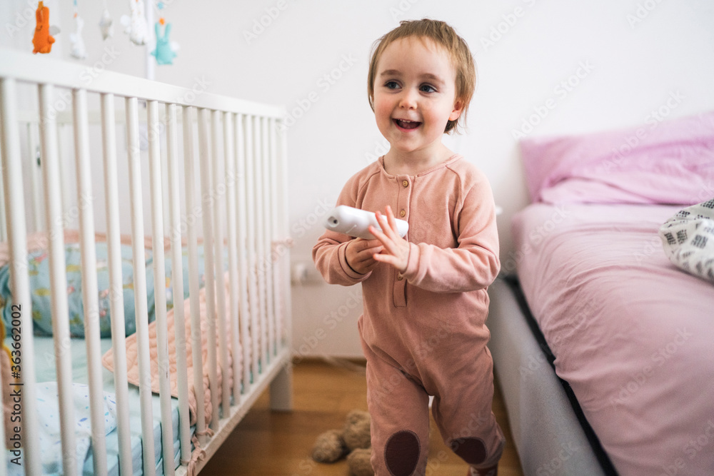 Cute little girl standing with remote controller Cute little girl standing with remote controller