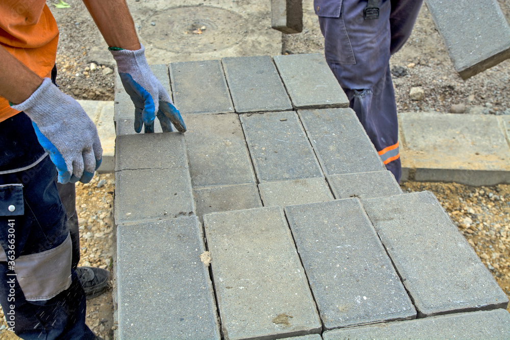 Laying concrete bricks for the sidewalk Laying concrete bricks for the sidewalk