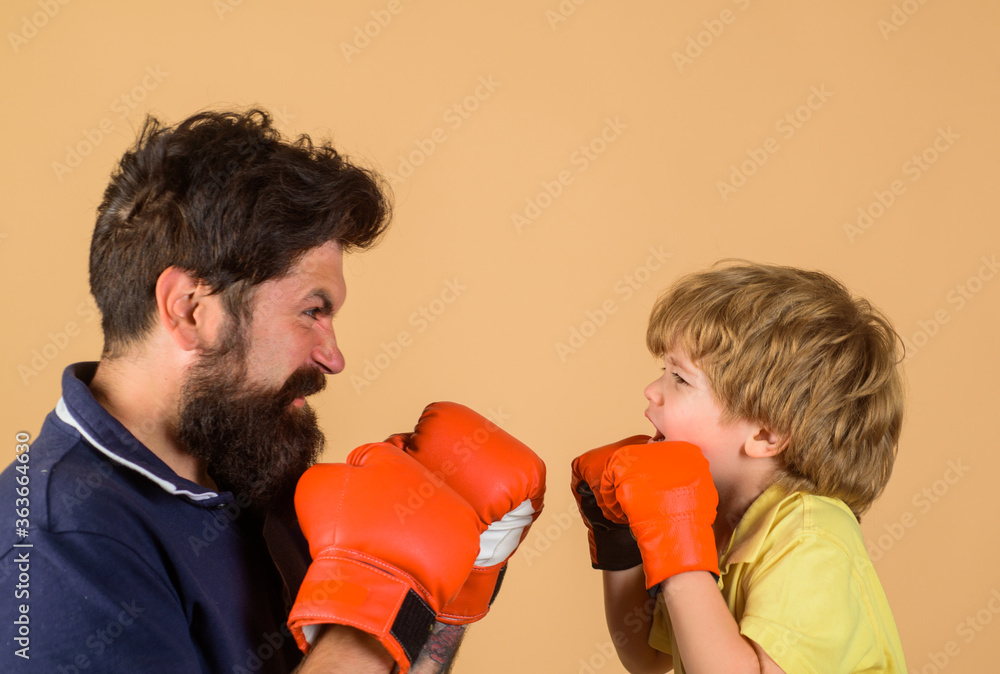 Boxing training. Kid in boxing gloves training with his coach. Boxing ring. Punching knockout. Childhood activity. Working out together. Fitness day. Trainer teaching kid. Boxing training. Kid in boxing gloves training with his coach. Boxing ring. Punching knockout. Childhood activity. Working out together. Fitness day. Trainer teaching kid.