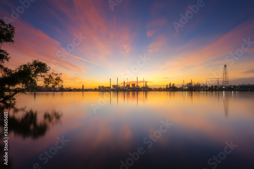 Fototapeta Naklejka Na Ścianę i Meble -  oil refinery plant chemical factory and power plant with many storage tanks and pipelines at sunrise