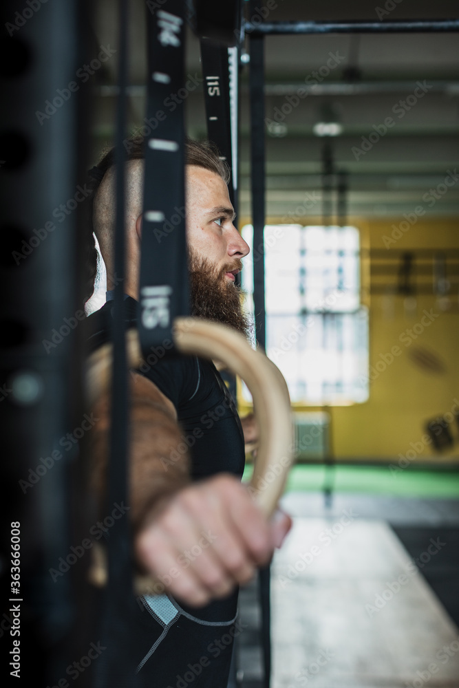 Strong and healthy man working out inside a crossfit gym. Strong and healthy man working out inside a crossfit gym.
