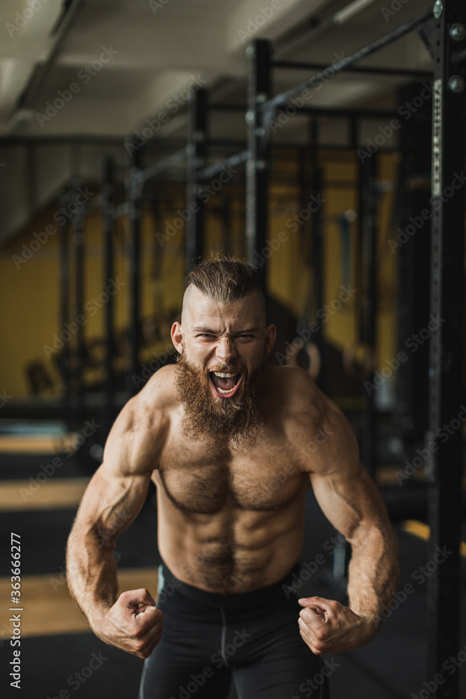 Strong and healthy man working out inside a crossfit gym. Strong and healthy man working out inside a crossfit gym.