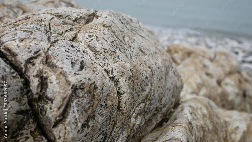 Rocky pebble stone shoreline with ocean waves background marine landscape close-up Rocky pebble stone shoreline with ocean waves background marine landscape close-up