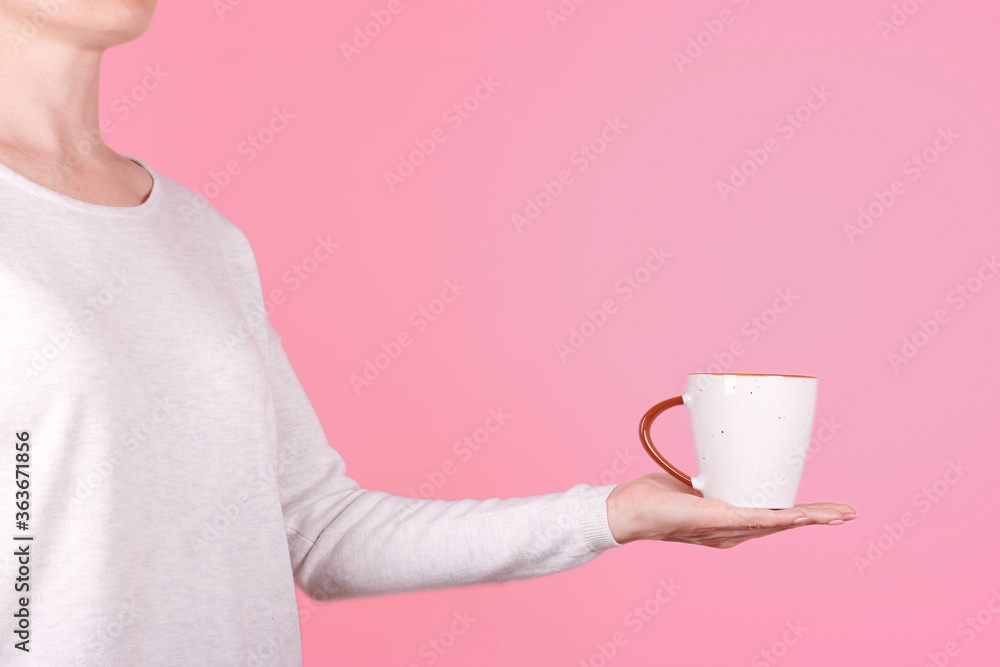 Hand with white coffee cup. Isolated on pink background. Hand with white coffee cup. Isolated on pink background.