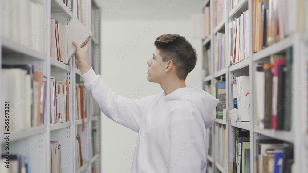 Student Taking Books from Bookshelf in Library