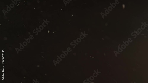 Dust particles background. Snowflakes texture. Blur white ash flying on dark. photo