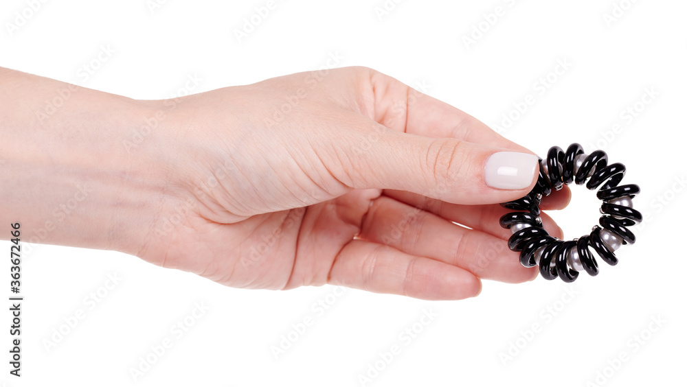 Hand with black plastic hair band with beads. Isolated on white background. Hand with black plastic hair band with beads. Isolated on white background.