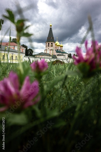 Russia  Valdai. Lake with a view of the Valdai Iversky monastery. Churches of Russia. Faith in God. Pilgrimage. Field with flowers and a cathedral.