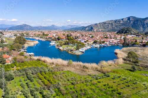 Fototapeta Naklejka Na Ścianę i Meble -  Dalyan canal view and settlement, excursion bout tour on Dalyan river valley. Dalyan is popular tourist destination in Turkey. Aerial view from drone.