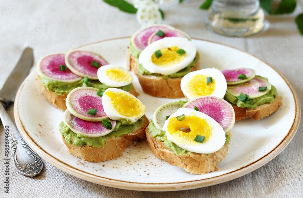 watermelon radish sandwich with avocado and egg. healthy balanced breakfast. bright toast watermelon radish sandwich with avocado and egg. healthy balanced breakfast. bright toast