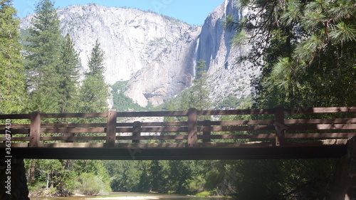 Pedestrian bridge in Yosemite National Park waterfall background