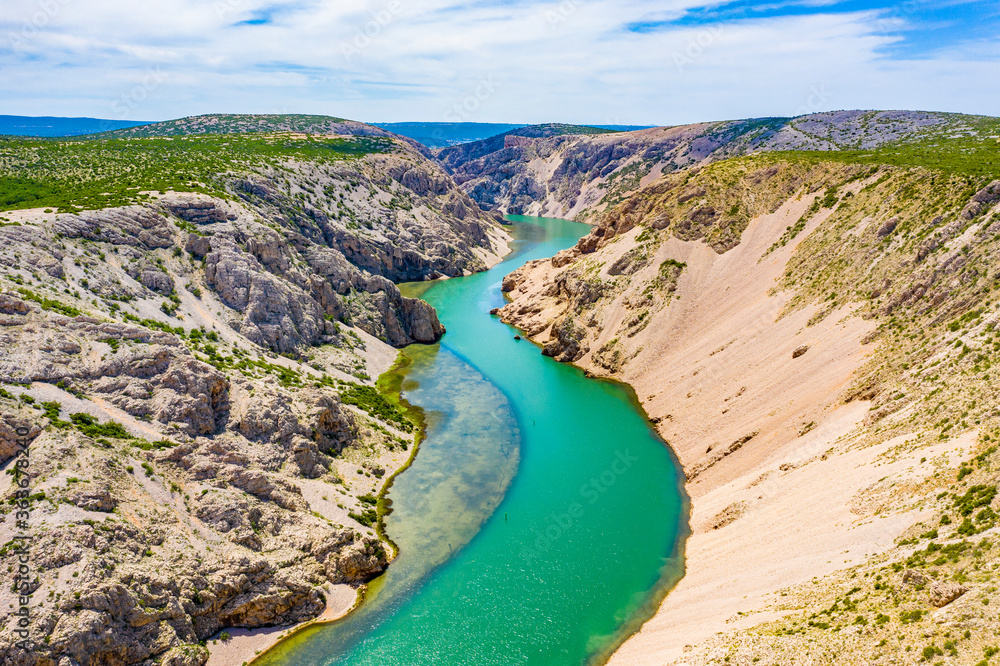 Fototapeta premium Green river with crystal clear water flowing in deep canyon. Zrmanja river canyon. Film location for Winnetou western movies. Beautiful Landscape in Croatia, EU, Europe.