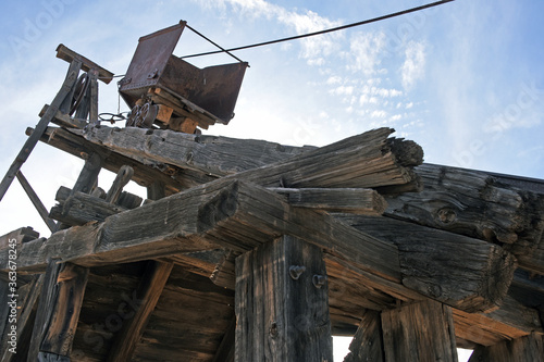 Looking up at an old mining cart on a wooden headframe in Vulture City, Arizona photo