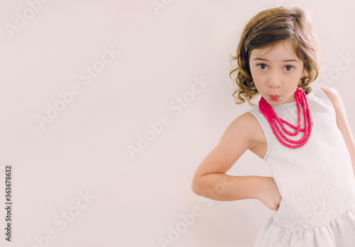 Confident Little Girl with a Moxie Look, Curls, Lips, and Attitude