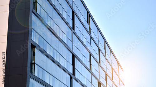 Modern apartment buildings on a sunny day with a blue sky. Facade of a modern apartment building. Glass surface with sunlight.