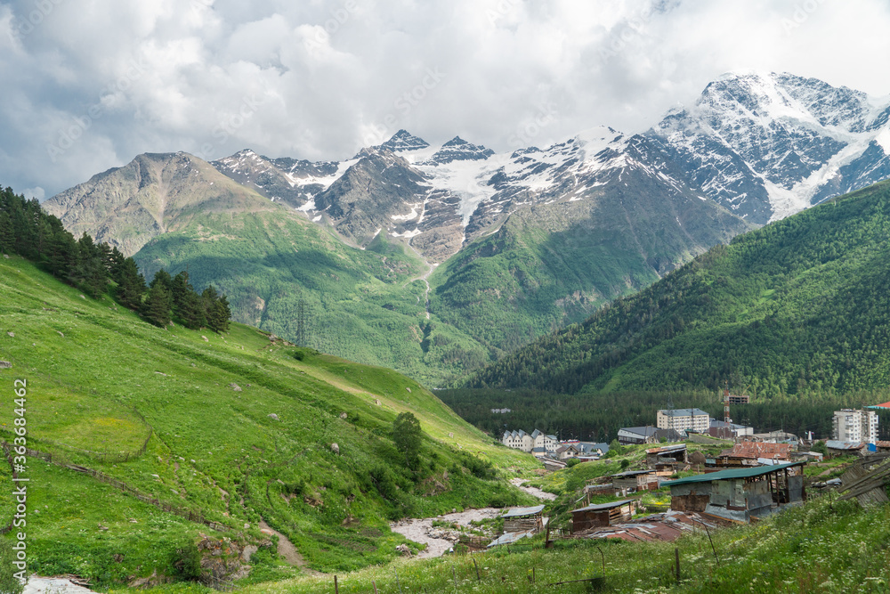 View of highest mountain village in mountains with cloudy sky. Beautiful landscape Caucasus.