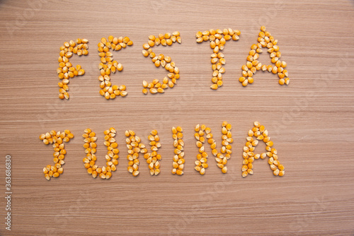 June party (Festa Junina) written with corn grains on wood. June party is a traditional Brazilian festival celebrated between June and July. Country party.