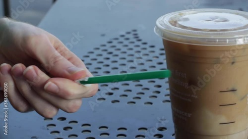  Putting Straw Into Iced Coffee