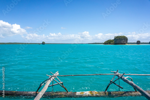 Boat trip on a traditional caledonian sailing boat in Upi bay, Isle of pines, New Caledonia. typical rocks in turquoise sea