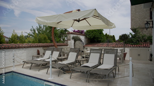 Modern deck chairs near the pool 