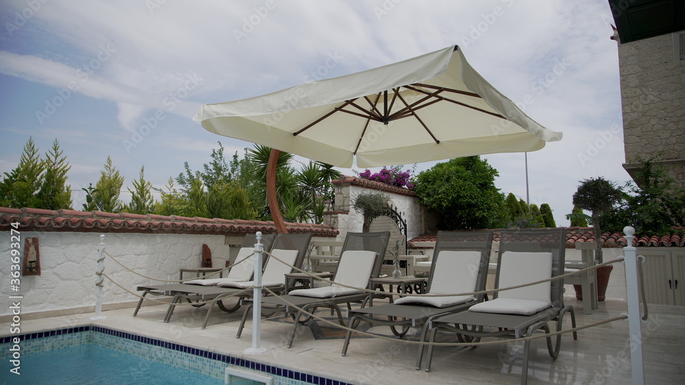 Fototapeta premium Modern deck chairs near the pool 