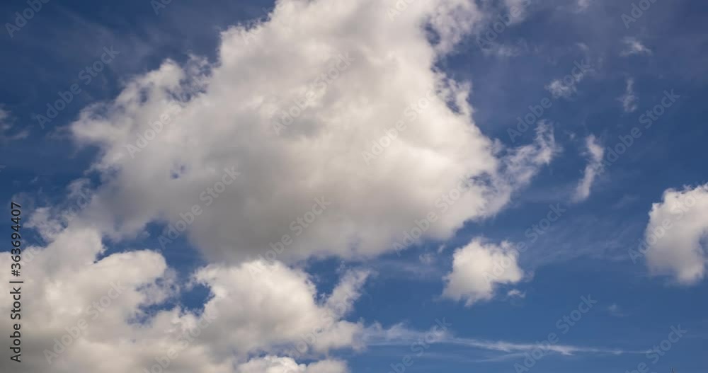 Time lapse clip of several fluffy curly rolling cloud layers in windy weather at blue sky Time lapse clip of several fluffy curly rolling cloud layers in windy weather at blue sky