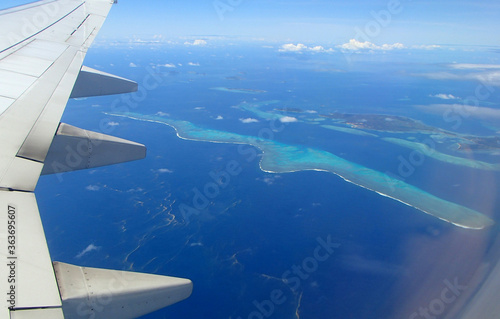 Fiji island sky view with wing and porthole of the plane