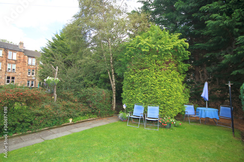 back garden with blue chairs