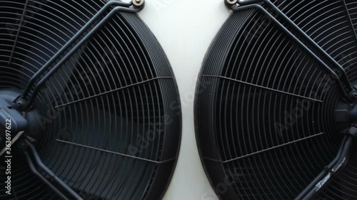 Wallpaper Mural Panning shot of two large industrial air conditioning condenser fans slowly rotating Torontodigital.ca