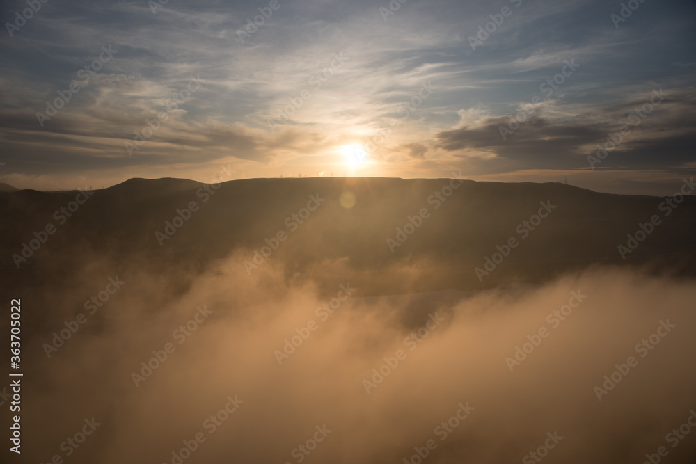 Orange sunset view at mountains in Azerbaijan. Cloudy weather.