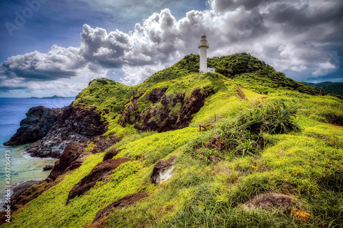 Ogan-zaki lighthouse and coastline in daytime. Ishigaki Island, Okinawa, Japan photo