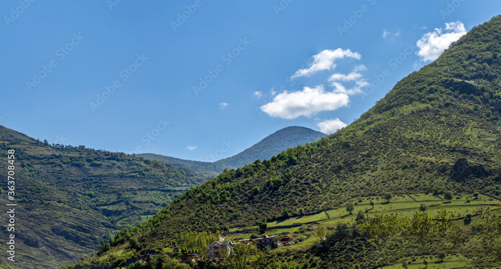 blue sky over the green hills and mountains