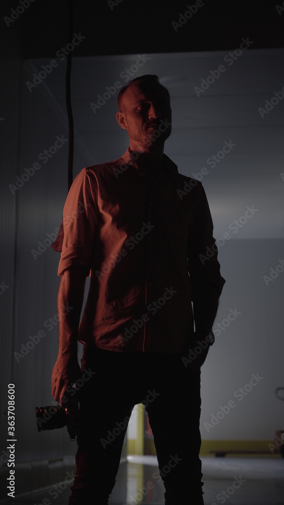 Man with black background and purple and magenta colored lights Man with black background and purple and magenta colored lights