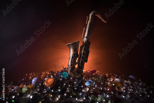 Canvas Print Alto gold sax miniature with colorful toned light on foggy background