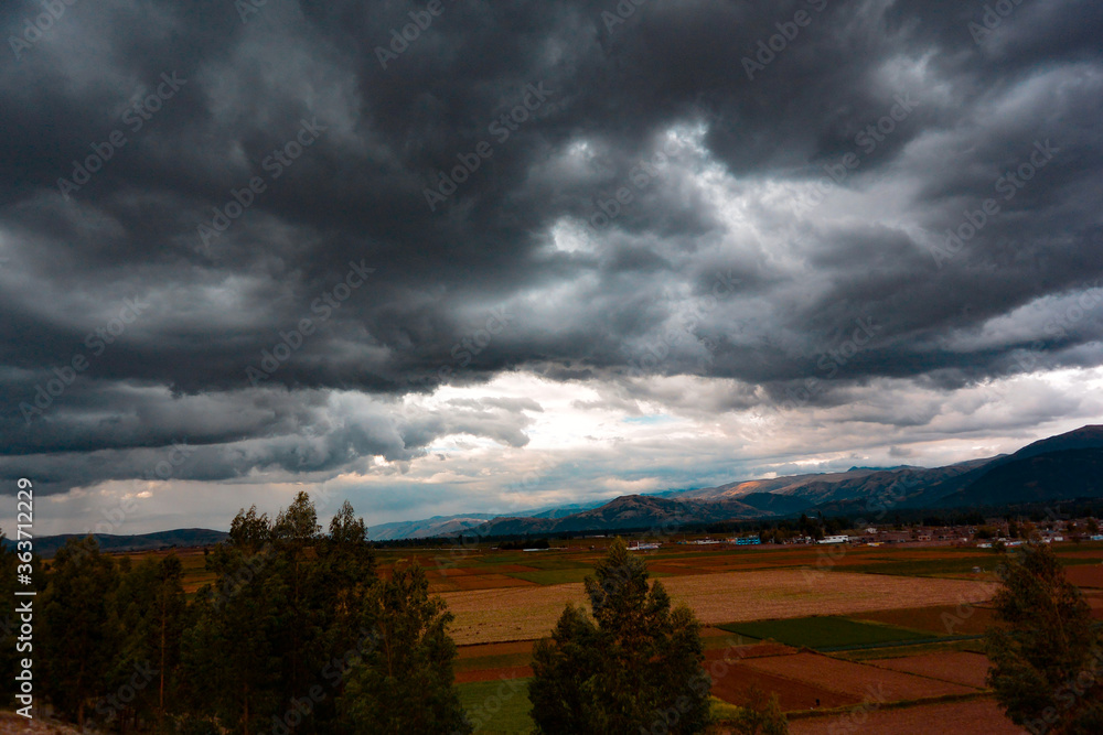storm clouds over fields las hermosas pampas del valle del mantaro a las orillas del rió mantaro en Huancayo 
una magnifica vista de este hermoso lugar una fecha de lluvias noviembre 