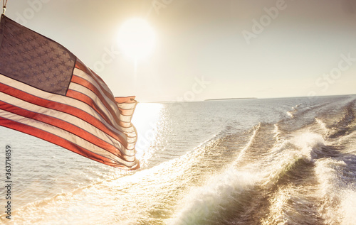 American Flag Waving in the Wind While on the Water
