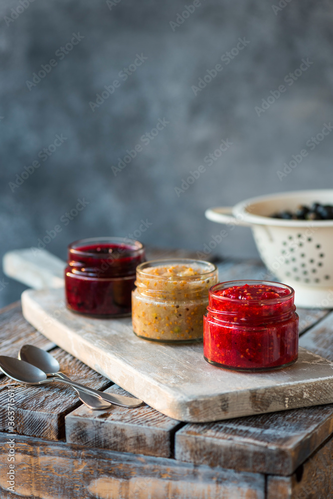 jars of black, red and yellow currant jam