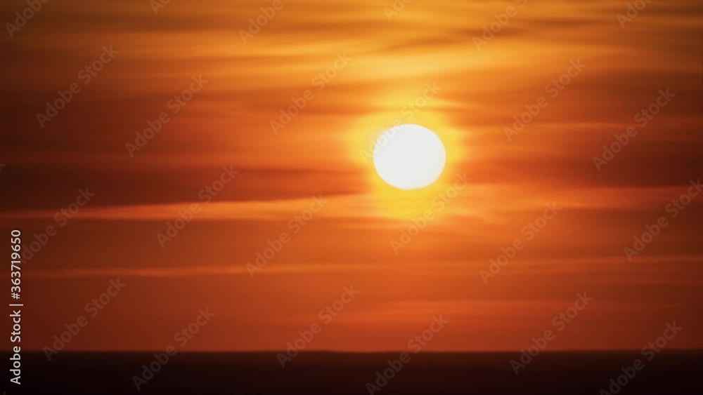 Timelapse of the Golden sunset. The sun moves through the clouds to the horizon Timelapse of the Golden sunset. The sun moves through the clouds to the horizon