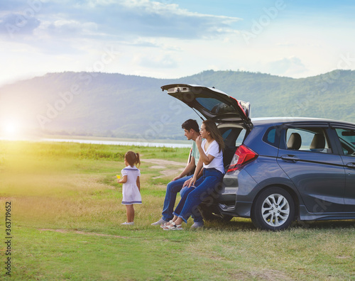Asian family.happy little girl with family sitting in the car.Car insurance concept