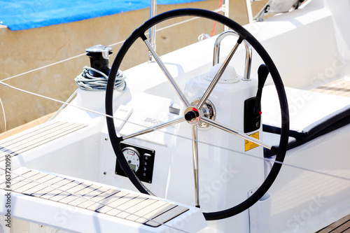 Close-up. Round steering wheel of a white boat. Cruise theme