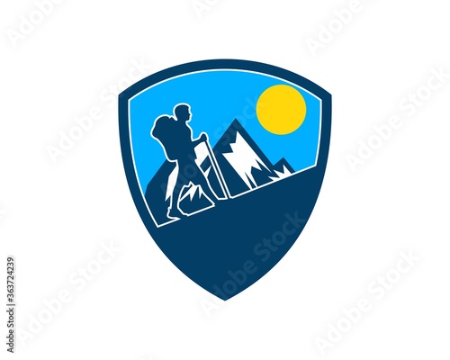Mountain hiking people inside the shield shape