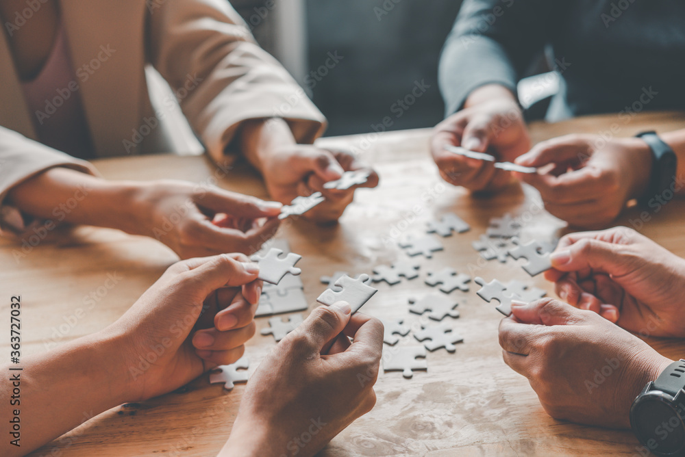 Business team handle a piece of white puzzles that are about to drop to get a complete worksheet - An attempt to succeed. Business team handle a piece of white puzzles that are about to drop to get a complete worksheet - An attempt to succeed.