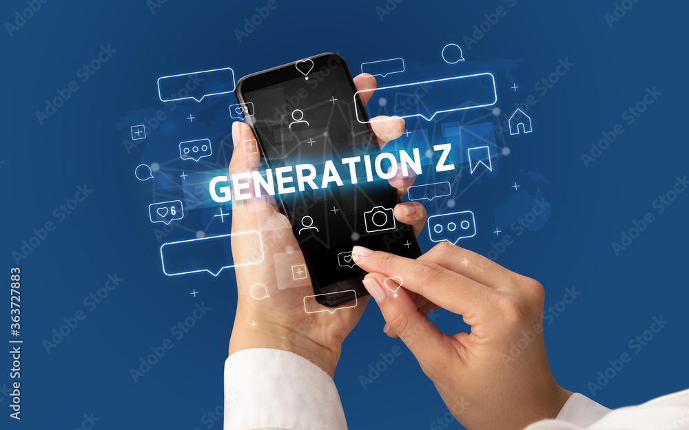 Female hand typing on smartphone with GENERATION Z inscription, social media concept Female hand typing on smartphone with GENERATION Z inscription, social media concept