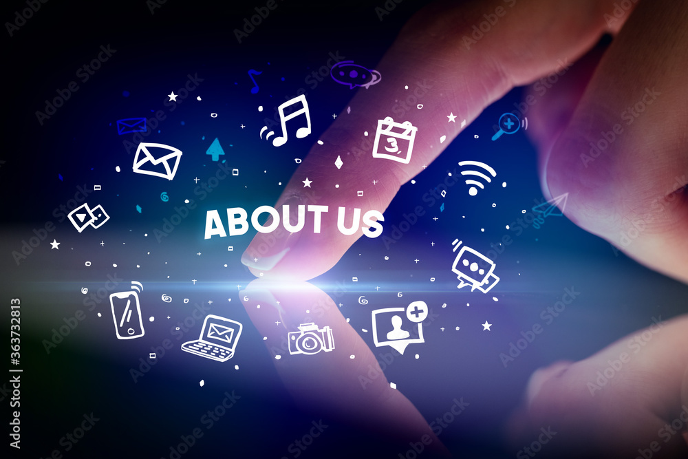 Finger touching tablet with drawn social media icons and ABOUT US inscription, social networking concept Finger touching tablet with drawn social media icons and ABOUT US inscription, social networking concept